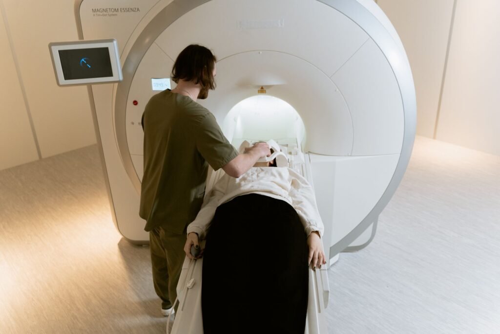 Radiographer operating a CT scanner console